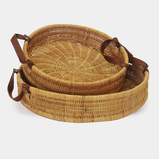 two round wicker baskets with leather handles