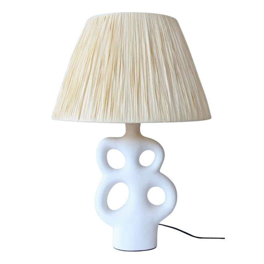 white ceramic cutout table lamp base with raffia lampshade for bedroom or living area
